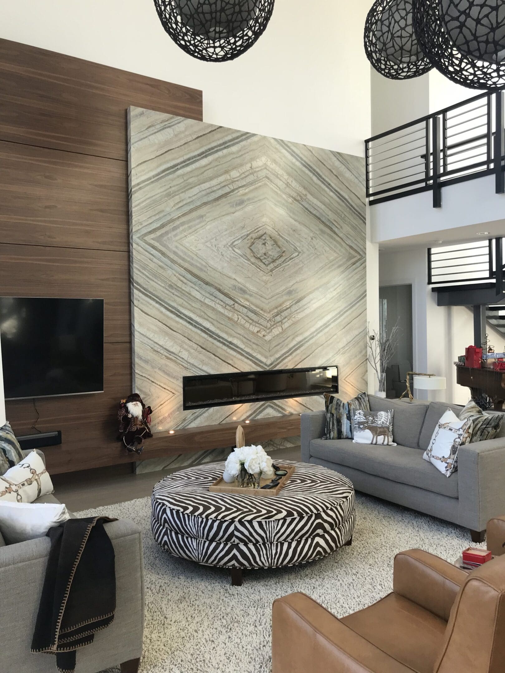 A living room with a fireplace and a large wall.