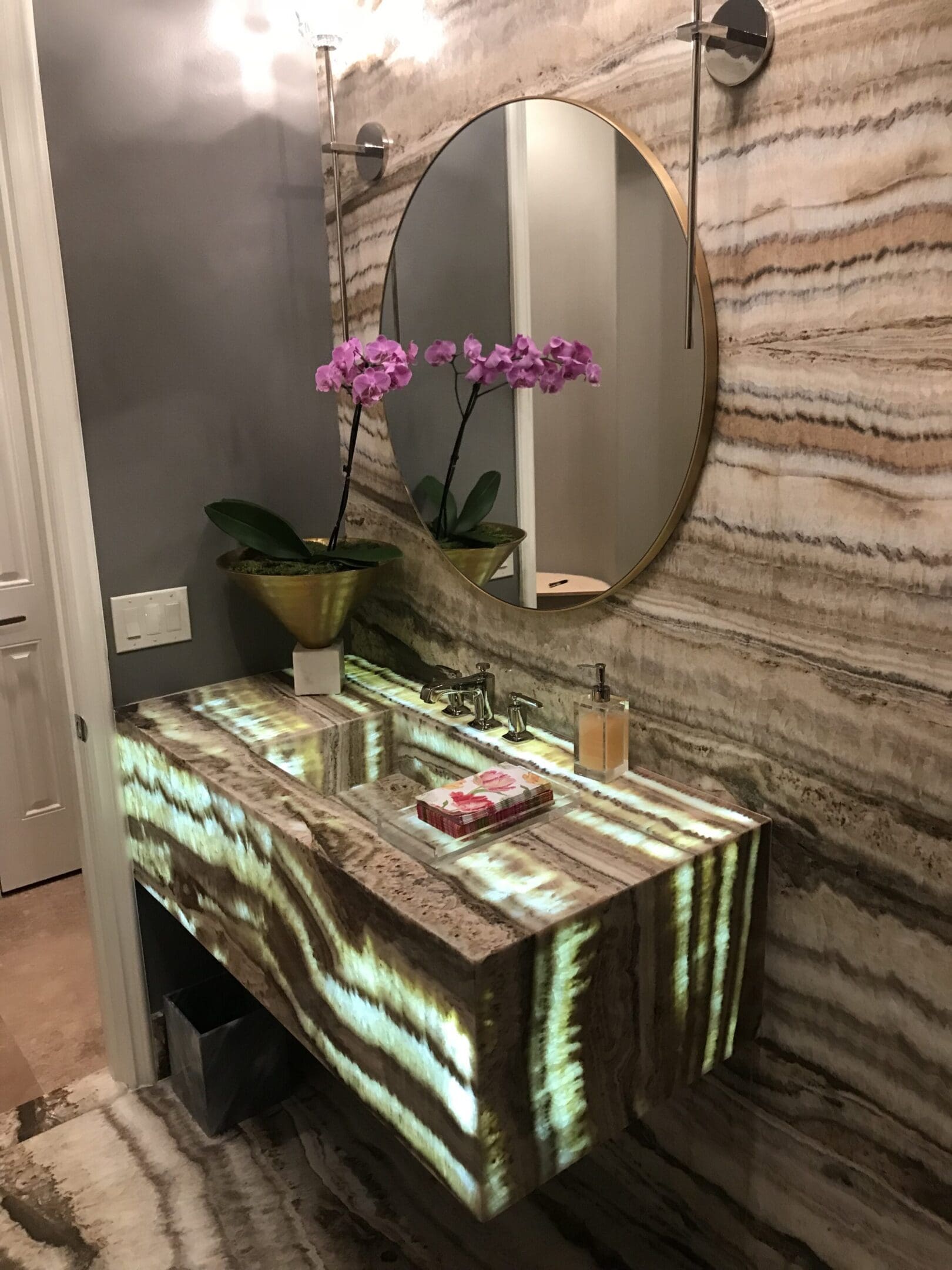 A bathroom with a sink and mirror in it