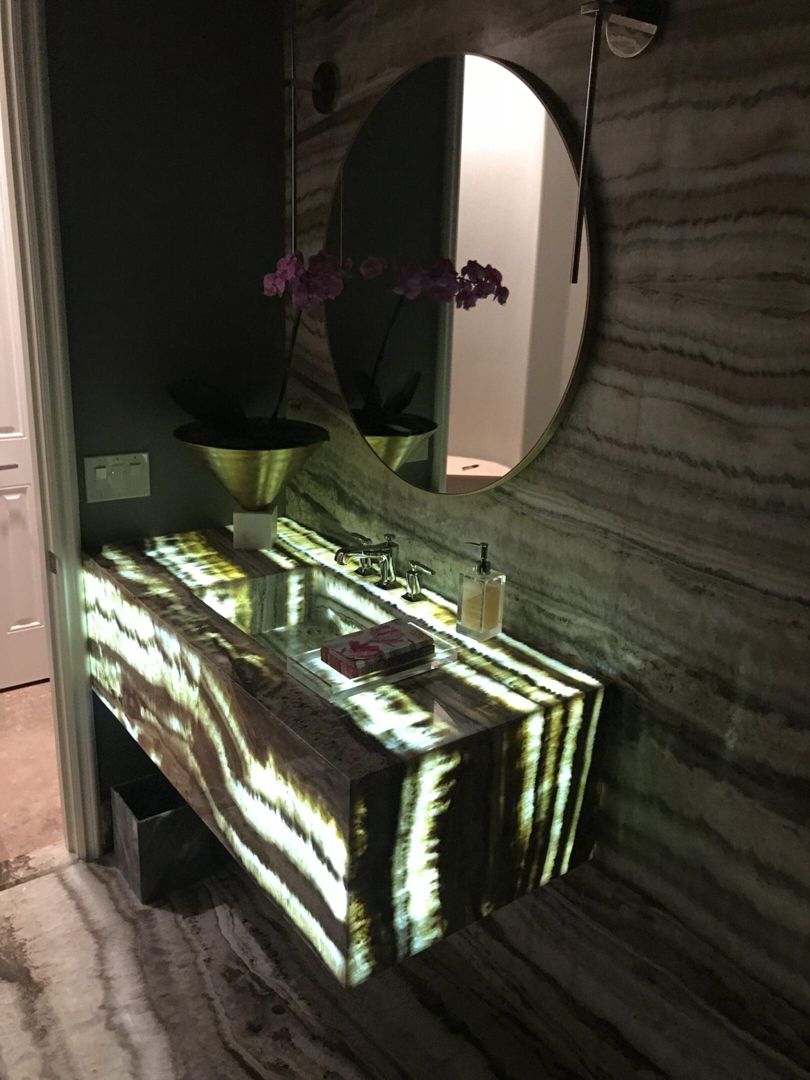 A bathroom with a sink and mirror in it