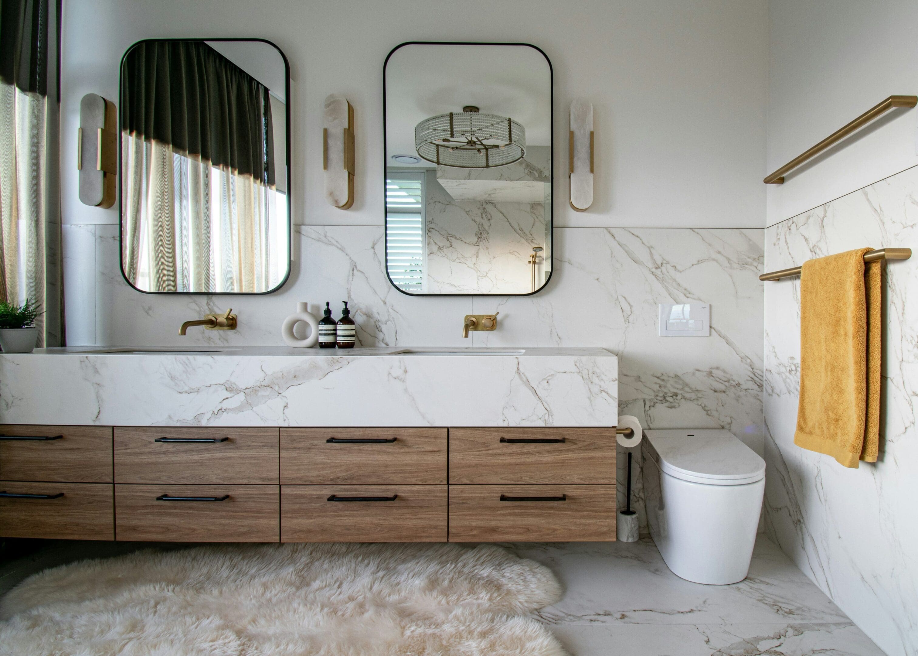 A bathroom with two mirrors and a sink